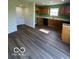 Open kitchen featuring wooden cabinets, laminate countertops, and access to the yard at 7549 Stockard St, Indianapolis, IN 46239