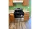 Kitchen with a stainless steel oven and wooden cabinets, offering a practical cooking space at 7549 Stockard St, Indianapolis, IN 46239