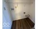 Utility room featuring hookups and shelving with wood-look flooring at 7549 Stockard St, Indianapolis, IN 46239