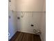 Utility room featuring hookups and shelving with wood-look flooring at 7549 Stockard St, Indianapolis, IN 46239