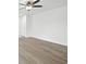 Bright living area with a ceiling fan, light wood flooring, and neutral walls, creating a modern space at 7549 Stockard St, Indianapolis, IN 46239