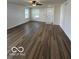 Bright living room with wood-look floors and a view of the front door at 7549 Stockard St, Indianapolis, IN 46239