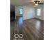Spacious living room with wood-look floors and ample natural light at 7549 Stockard St, Indianapolis, IN 46239