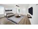 Bright living room featuring neutral walls, wood floors, and comfortable seating arrangement at 7549 Stockard St, Indianapolis, IN 46239