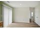 Bright living area with modern sliding glass doors, neutral walls, and wood-look flooring throughout at 7549 Stockard St, Indianapolis, IN 46239