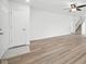 Spacious living room with hard wood floors, and front door access to the main stairwell at 7549 Stockard St, Indianapolis, IN 46239