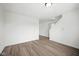 Well-lit living room with wood-look floors, light walls, and entry way to the home's upper level at 7549 Stockard St, Indianapolis, IN 46239