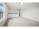 Spacious loft area with neutral carpet, bright natural light and a half wall with wooden banister at 7549 Stockard St, Indianapolis, IN 46239