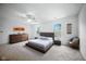 Spacious primary bedroom with a platform bed, two windows, ceiling fan, and neutral decor at 7549 Stockard St, Indianapolis, IN 46239