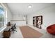 Home office with desk, chair, bookshelf, and natural light, perfect for remote work or study at 7549 Stockard St, Indianapolis, IN 46239