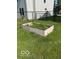 Small raised garden bed next to black chain link fence in the yard at 7549 Stockard St, Indianapolis, IN 46239