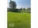 Large grassy yard with view of pond, and several surrounding homes at 7549 Stockard St, Indianapolis, IN 46239
