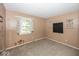 Carpeted bedroom bathed in natural light, offering a blank canvas for personalization and comfort at 7940 Benjamin Dr, Lawrence, IN 46226
