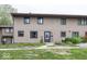 Exterior view of the townhome, featuring a well-manicured lawn and neutral-colored siding at 7940 Benjamin Dr, Lawrence, IN 46226