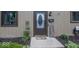 Close up of the front door with decorative glass, house number, and landscaping at 7940 Benjamin Dr, Lawrence, IN 46226
