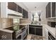 Galley kitchen boasts modern appliances and a functional layout, maximizing space and efficiency at 7940 Benjamin Dr, Lawrence, IN 46226
