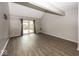 Bright living room showcasing wood-look flooring, neutral walls, and a sliding door at 7940 Benjamin Dr, Lawrence, IN 46226