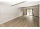 Spacious living room with wood-look flooring and a sliding glass door to the outside at 7940 Benjamin Dr, Lawrence, IN 46226
