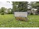 Community sign for Franklin Trails Condominiums with landscaped bushes and trees at 7940 Benjamin Dr, Lawrence, IN 46226