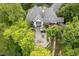 Stunning aerial view of a luxurious home with a stone patio, outdoor seating, and lush landscaping at 8301 Reef Ct, Indianapolis, IN 46236