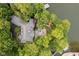 Breathtaking aerial view of a waterfront estate with lush surroundings, a private dock, and expansive patio at 8301 Reef Ct, Indianapolis, IN 46236