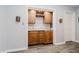 Cozy bar with wooden cabinets, wine rack, backsplash and beverage fridge at 8301 Reef Ct, Indianapolis, IN 46236