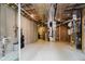 Unfinished basement, highlighting the utilities, water heater, and exposed ceiling at 8301 Reef Ct, Indianapolis, IN 46236