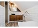 Attic bathroom features a modern vanity with a vessel sink, wood floors, and white subway tile at 8301 Reef Ct, Indianapolis, IN 46236