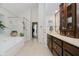 Bright bathroom with large tub, glass shower, and double vanity with modern fixtures at 8301 Reef Ct, Indianapolis, IN 46236