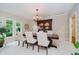 Elegant dining room with a chandelier, large windows, and a beautiful display cabinet for formal entertaining at 8301 Reef Ct, Indianapolis, IN 46236