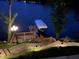Illuminated waterfront dock with seating area and boat lift at night at 8301 Reef Ct, Indianapolis, IN 46236