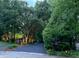 Picturesque driveway leading to a well-lit home surrounded by mature trees at 8301 Reef Ct, Indianapolis, IN 46236