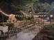 Outdoor event with seating, outdoor kitchen and fireplace, lit by string lights at 8301 Reef Ct, Indianapolis, IN 46236