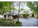 Picturesque view of a stately home featuring a large driveway, three-car garage, and lush greenery at 8301 Reef Ct, Indianapolis, IN 46236