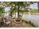 Lakeside outdoor firepit area with stone pavers and beautiful views at 8301 Reef Ct, Indianapolis, IN 46236
