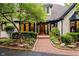 Charming home featuring a brick walkway that leads to a beautiful wood and glass front door surrounded by lush landscaping at 8301 Reef Ct, Indianapolis, IN 46236