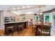 Spacious eat-in kitchen with light colored cabinets, hardwood floors, island with seating, and stainless steel appliances at 8301 Reef Ct, Indianapolis, IN 46236