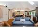 Open kitchen and living space with vaulted ceilings, hardwood floors, stainless appliances, and light-colored cabinets at 8301 Reef Ct, Indianapolis, IN 46236