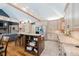 Eat-in kitchen with seating at the island, light-colored cabinets, granite countertops, and stainless steel appliances at 8301 Reef Ct, Indianapolis, IN 46236