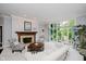 Bright and airy living room with a fireplace, large windows showcasing the outdoor view, and comfortable seating at 8301 Reef Ct, Indianapolis, IN 46236