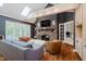 Cozy living room with hardwood floors, stone fireplace, comfortable seating, and natural light from skylights at 8301 Reef Ct, Indianapolis, IN 46236