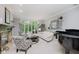 Bright living room with large windows, neutral color palette, fireplace, and comfortable seating arrangement at 8301 Reef Ct, Indianapolis, IN 46236