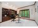 Home office featuring built-in bookshelves, a large window with views, and a comfortable workspace at 8301 Reef Ct, Indianapolis, IN 46236