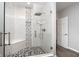 Modern glass enclosed shower with bench, mosaic floor, rainfall shower head and handheld at 8301 Reef Ct, Indianapolis, IN 46236