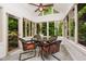 Enclosed sunroom with tile floors, natural light, and views of the backyard at 8301 Reef Ct, Indianapolis, IN 46236