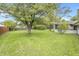 Spacious backyard with mature trees and lush green grass at 9010 Deer Run Dr, Indianapolis, IN 46256