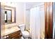 Cozy bathroom features a vanity, toilet, and shower with a curtain, perfect for functionality and comfort at 9010 Deer Run Dr, Indianapolis, IN 46256