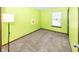 Bright bedroom with light-green walls, plush carpeting, window, and minimalist decor, creating a cozy atmosphere at 9010 Deer Run Dr, Indianapolis, IN 46256