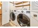 Convenient laundry room featuring a modern washer and dryer set and shelving at 9010 Deer Run Dr, Indianapolis, IN 46256