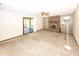Bright living room with brick fireplace, ceiling fan, and sliding glass door to screened in porch at 9010 Deer Run Dr, Indianapolis, IN 46256